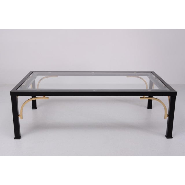 Superb coffee table .Black High Gloss Wooden frame and comes with solid Brass arches and Balls . The top is made off brand...