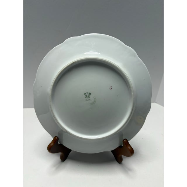 This elegant antique German porcelain plate features finely hand-painted pink floral garlands, delicate ribbon motifs, and...