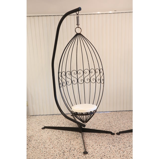 A pair of 1960's wrought iron hanging chairs featuring the original black finish, plus newly made 2" thick off-white...