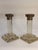An elegant pair of Neoclassical Revival candlesticks featuring silver-plated Corinthian capitals above substantial clear...