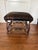 Rustic stool by Theodore Alexander showcases a base of high-strength composite “antlers”, hooved feet, and faux hair on...