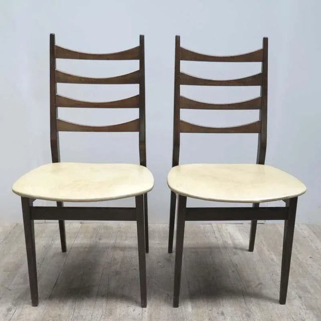 Even though produced in Germany, these chairs were designed in a Scandinavian style. They have a skai leather seats.