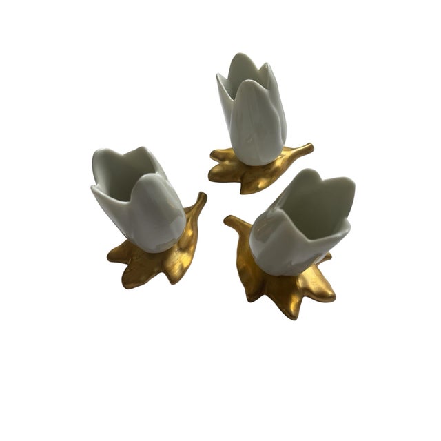 Set of three 1950s Italian porcelain and gold match holders. The design resembles a gold leaf and white tulip.