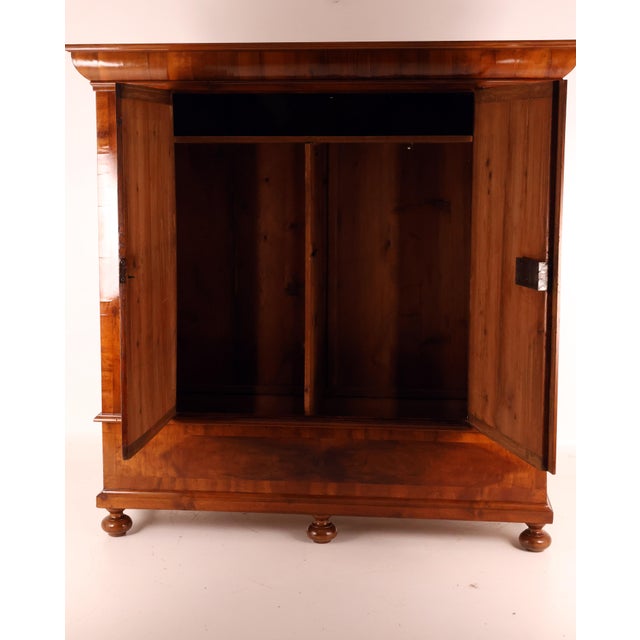 A very beautiful original wardrobe from the second half of the 18th century, featuring a large cornice, two doors inlaid...