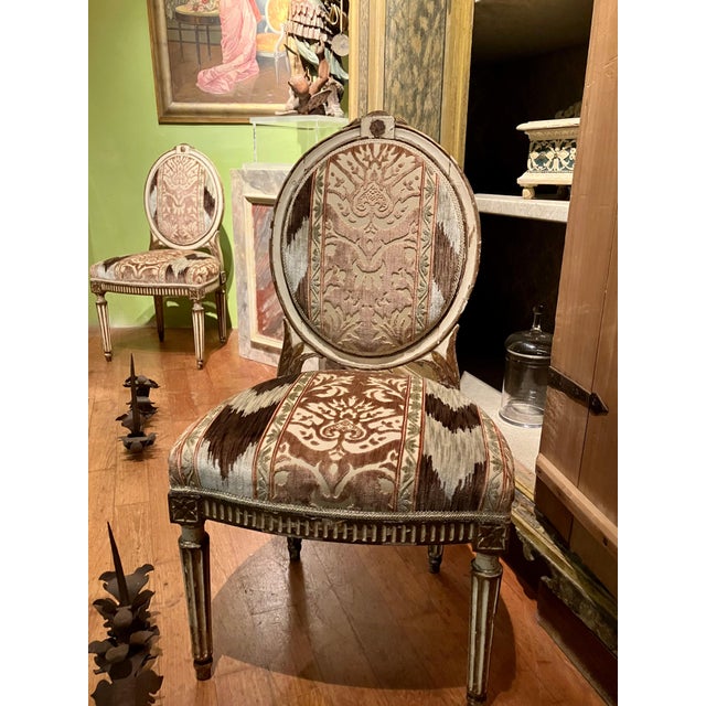 Elegant pair of louis xvi period white ivory lacquer and gilt chairs, boasting exquisite hand-carved craftsmanship and...