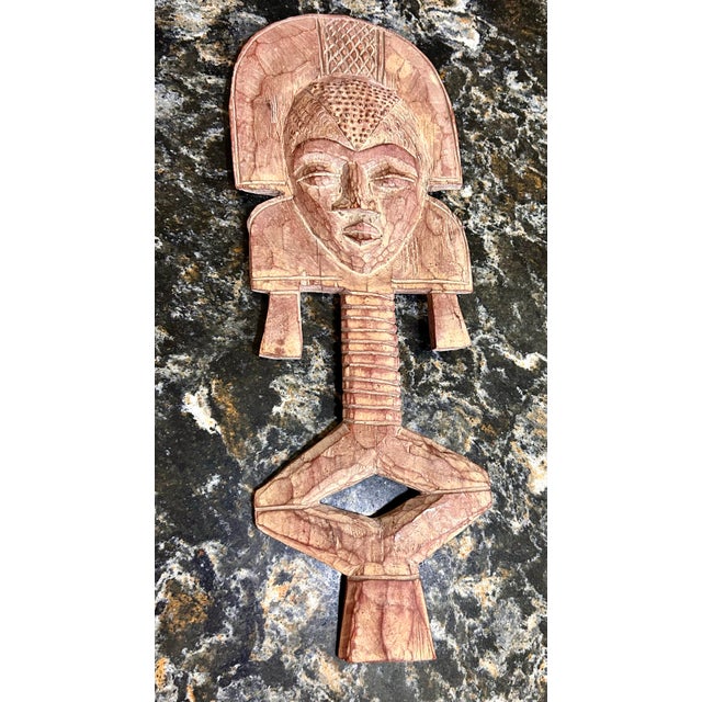 These are a pair of African, hand-carved, wooden, tribal figures with unique faces and headdresses. These types of...