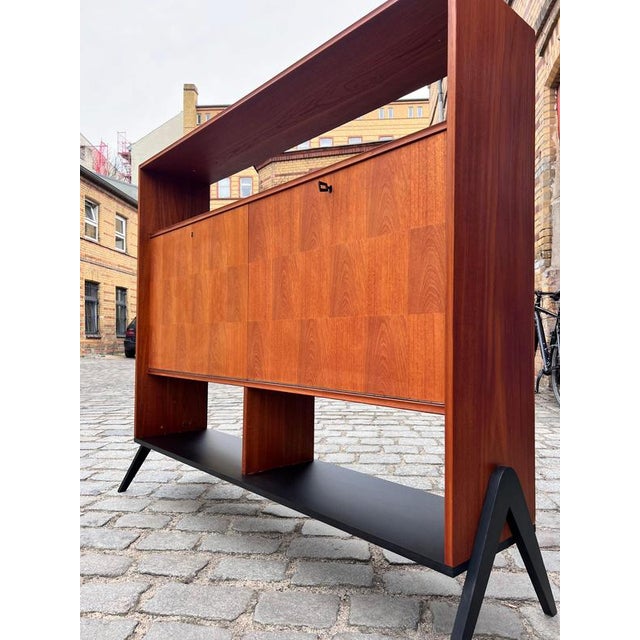 This wide teak shelving unit from Denmark is an exceptional piece of Scandinavian furniture craftsmanship, captivating...