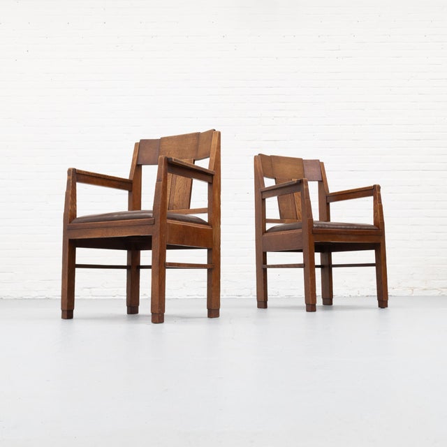 Dutch Art Deco dining armchair in the manner of the Hague School, dating from circa 1930 and executed in oak with a dark...