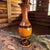 This vintage handmade turned wood floor table vase stands at a tall 24 inches, exuding a rustic charm that is perfect for...