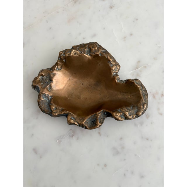 The Bronze Vide-Poche ash tray by Michel Jaubert displays freeform designs with an organic rim. Reminiscent of its...