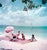 Jamaica Parasol by Toni Frissell An intimate group of people enjoying a conversation in the sunshine on a pastel pink...