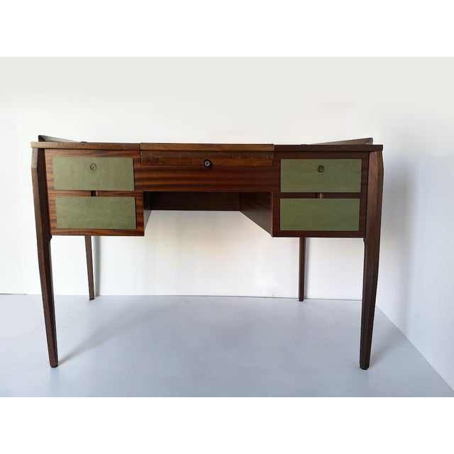 Vintage 1950s desk in the style of Vittorio Dassi, crafted from mahogany with a polished finish. The supporting structure...