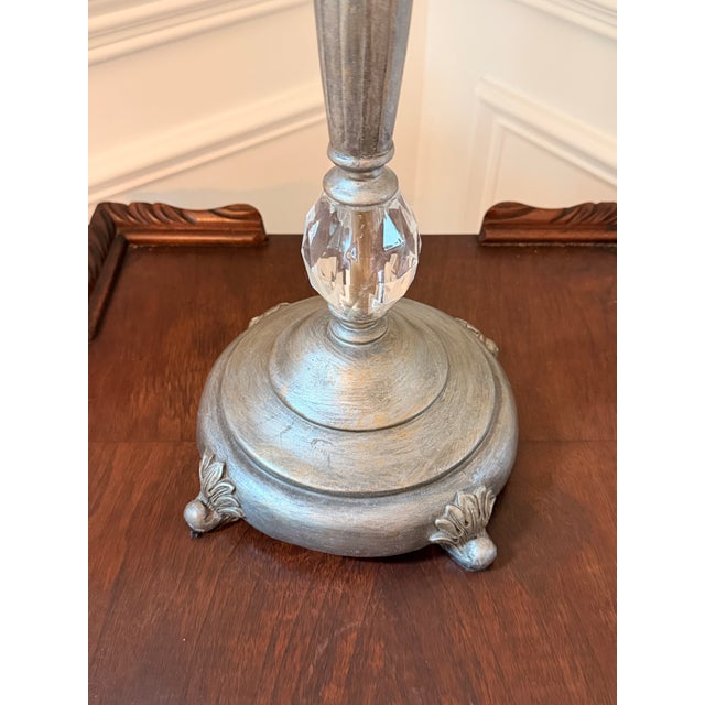 Elegant pair of silvered table lamps featuring elongated baluster-form bodies with crystal accents, decorative leaf...