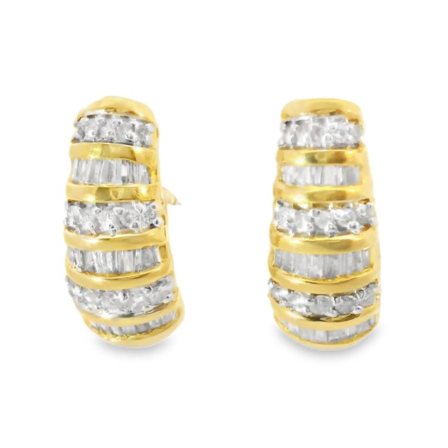 14K yellow gold estate earrings featuring 15 brilliant round diamonds and numerous baguette diamonds, totaling 1.40...