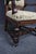 An antique Renaissance Revival throne armchair crafted in quarter sawn oak, featuring a carved crest with scrolling...