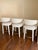 A stunning set of three Hagen counter stools featuring sculptural lines, plush ivory bouclé upholstery, and an elegant...