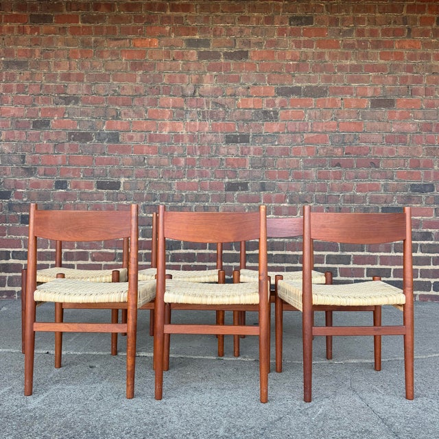 This is a beautiful set of 6 Danish, teak and rush dining chairs designed by Hans Wegner. The darker teak wood contrasts...