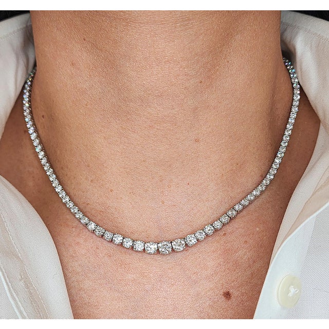 This elegant necklace is a 16-inch platinum diamond necklace. It features 125 round cut diamonds weighing 9.15 carats,...