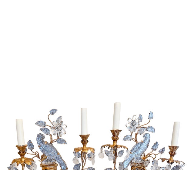 This is a fantastic pair of Maison Baguès wall sconces featuring finely carved crystal parrots perched among gilt metal...
