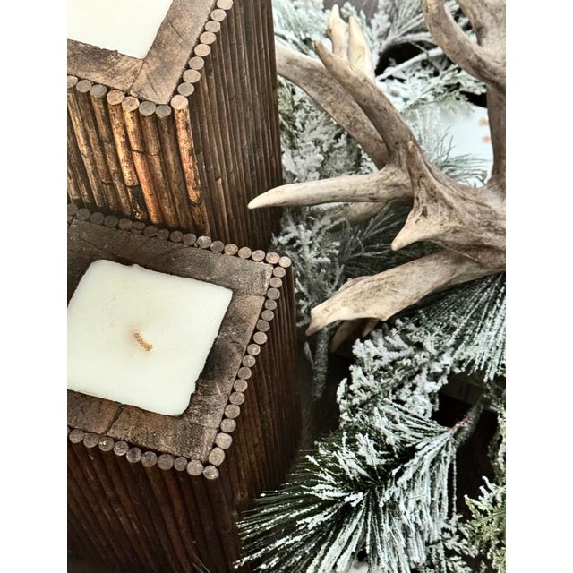 A wintery cabin lodge candle pair featuring natural wood construction. Tall, sturdy, and substantial in weight.