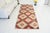 This is a vintage Turkish Oushak rug from the Mid 20th Century. The piece was hand-knotted.