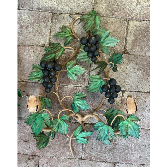 Fun pair of Italian tole candle sconces with grape clusters. A few rubs but ready to hang and use. Only ships to...
