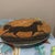 This charming pair of stoneware salad/dessert plates features the distinct Americana folk art of renowned artist Warren...