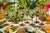 A vibrant set of seven hand-painted wine glasses featuring colorful toucans perched among lush tropical foliage. Each...