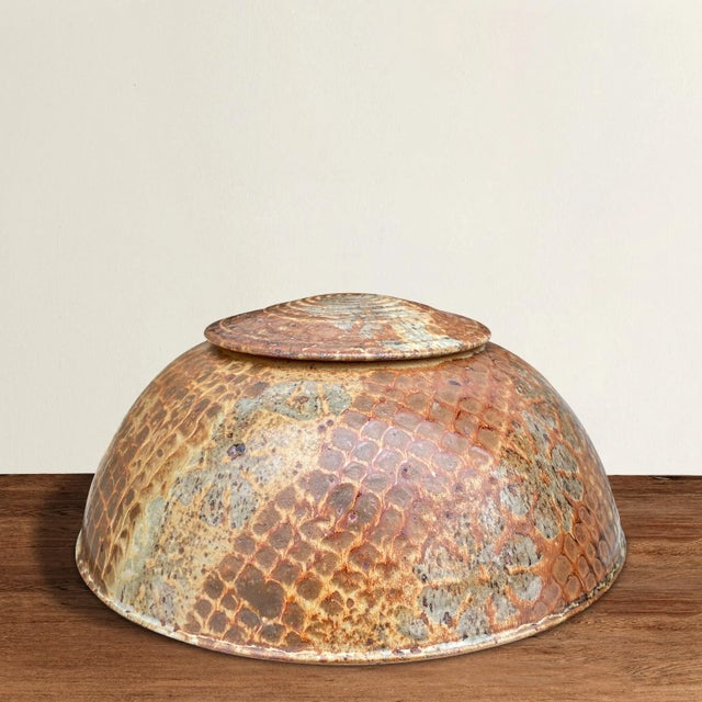 A fun and unique domed studio pottery lidded jar with a textured pattern reminiscent of snakeskin and with stamped...