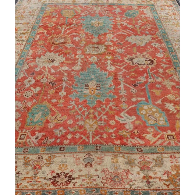 Traditional Early 20th Century Antique Turkish Oushak in Tribal Motifs in Soft Coral Blue Marigold and Cream For Sale - Image 3 of 13