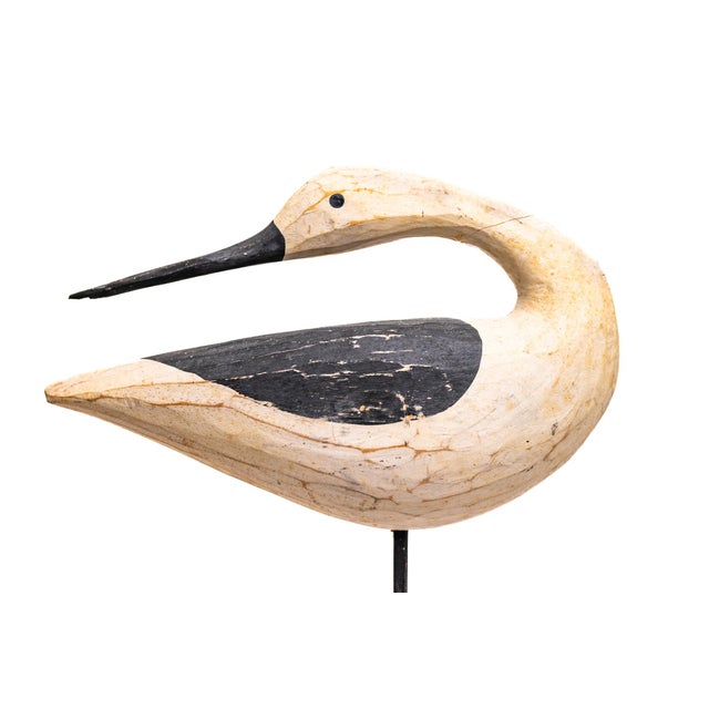 This hand-carved wooden shorebird captures the quiet elegance of coastal folk carving. With its elongated neck, gently...