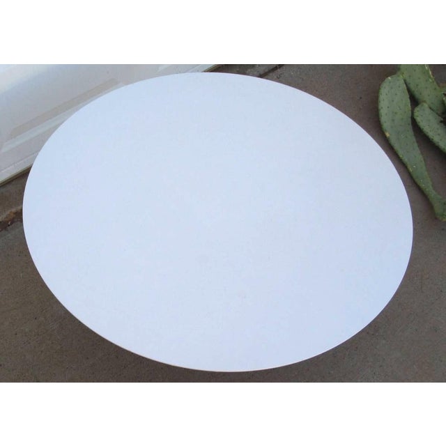 Vintage Mid Century Modern round Burke Tulip Coffee Table with a dark blue base. The table measures approximately 35-1/2...