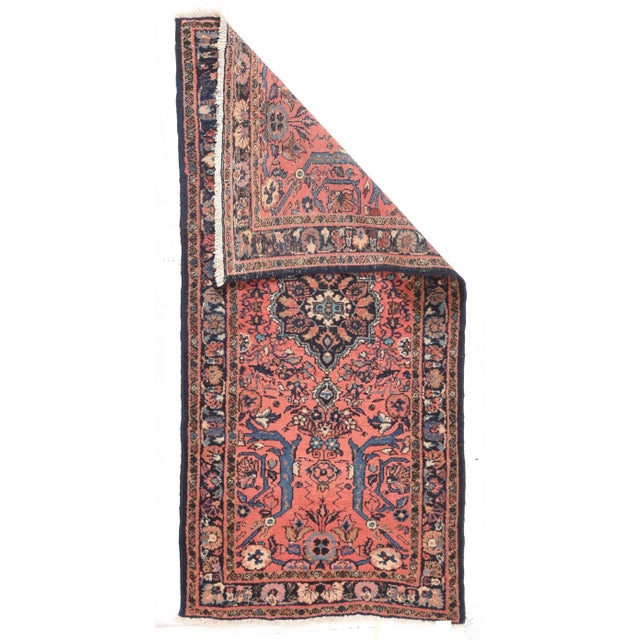 The light coral rose field is centered on a small navy medallion enclosing little lancet leaves around a crew oval...