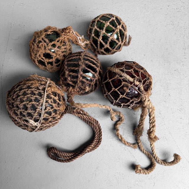 An atmospheric set of Japanese glass fishing floats, ukidama, originally used to keep fishing nets afloat. Dimensions:...