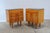 A clean-lined pair of nightstands with striking vertical wood grain and contrasting black glass tops. This set of two...