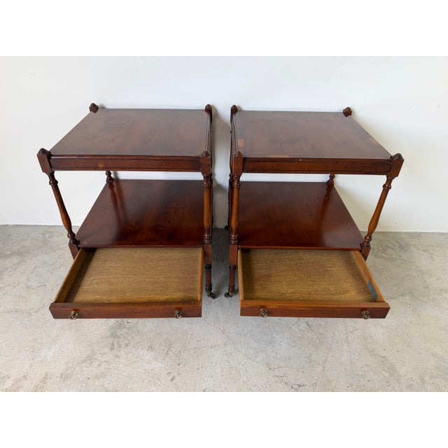 Elegant Hekman Regency-style end tables crafted from rich mahogany with striking olive wood veneer tops and shelves. Each...