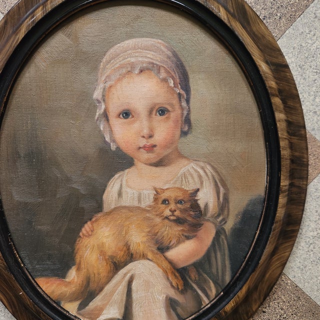 A very sweet somewhat creepy oil on canvas portrait painting of a little Victorian girl with her cat. Unsigned. Framed