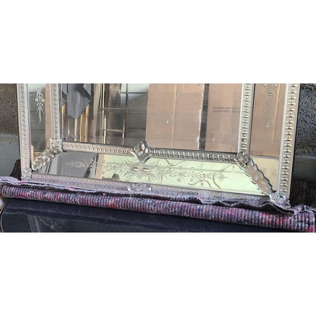 Rectangular Venetian mirror with a beveled center. The mirrors surrounding the main mirror are engraved with flowers and...