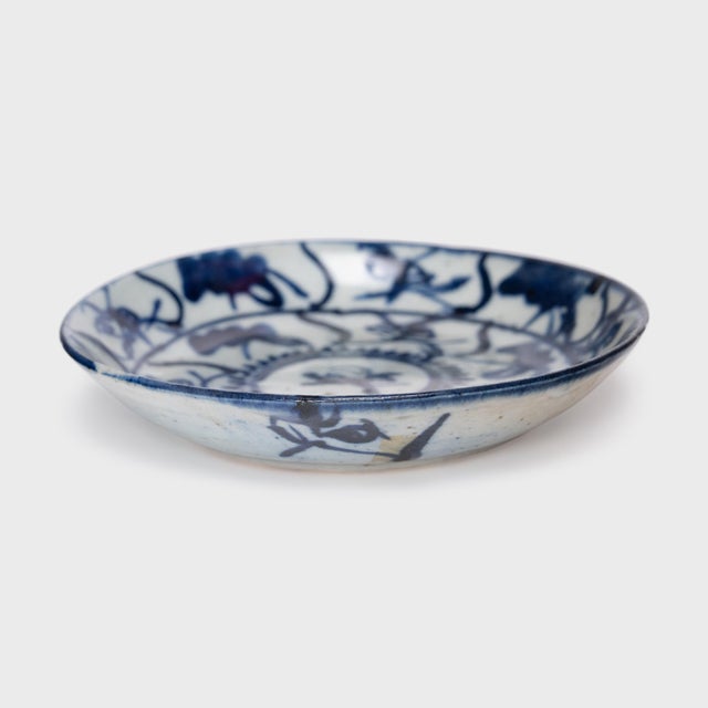 This 19th-century porcelain plate is hand-painted with cobalt underglaze in the blue-and-white manner, loosely brushed...