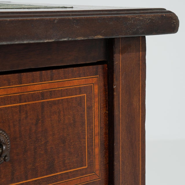 A refined Edwardian desk featuring a classic leather writing surface, combining practicality with understated elegance....