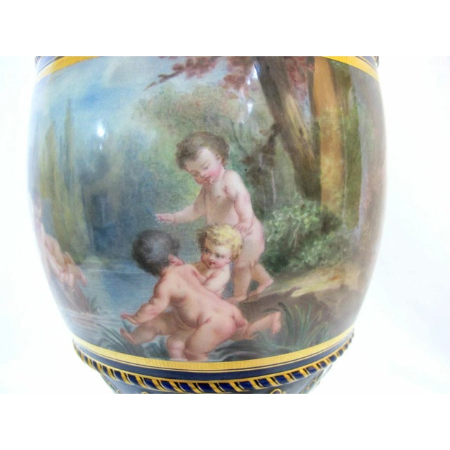 Gold gilt bronze mounted French porcelain covered urns, having Blue De Roi ground with heavy gilt decoration. Hand...