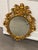 Ornate vintage Harrison & Gil Dauphine hand carved Rococo-style giltwood wall mirror in wonderful condition. Expert and...