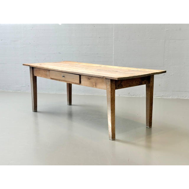 A rustic country-style table made of solid softwood with an authentic look and a beautiful patina that has developed over...