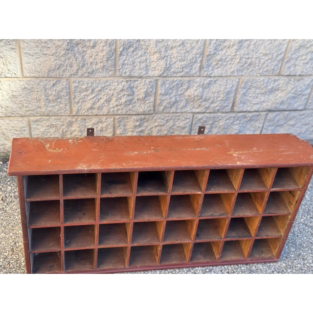 Vintage industrial wooden sorting cabinet featuring 32 open compartments arranged in four rows. The cabinet retains a...
