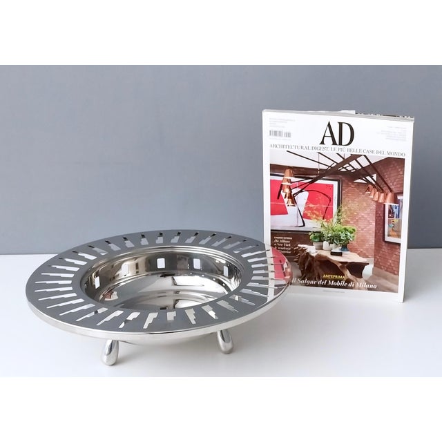 This Alessi stainless steel 3 footed cutout bowl is of deco inspired partial skyscrapers buildings in more of an abstract...