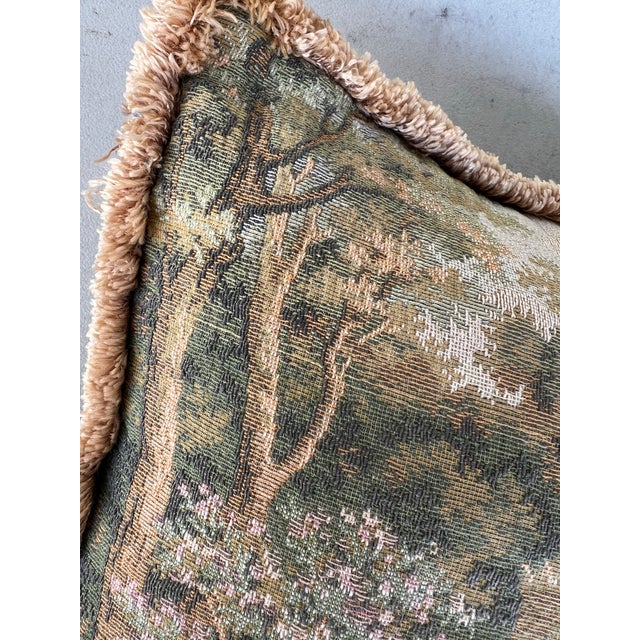 Vintage throw pillow with a tapestry scene on one side and green velvet on the other. The scenery is a beautiful landscape...