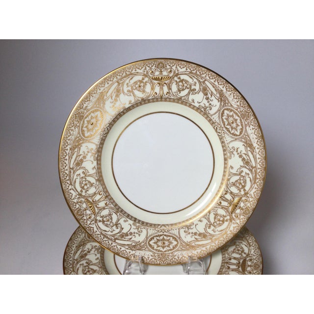A regal set of 12 elaborately gild service plates, by Royal Worcester. The set with delicate broad gilt borders with a...