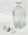 Sophisticated vintage decanter. Made of clear crystal with an etched design on the front. The design reminds me of...