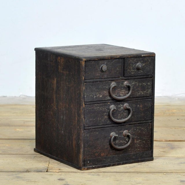 This small Japanese chest of drawers from circa 1900 is a characterful and authentic piece of furniture that beautifully...