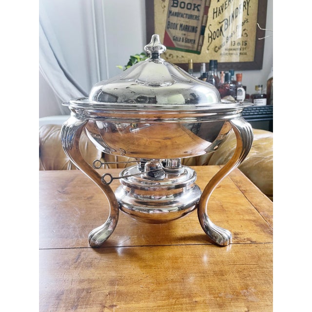A beautiful antique circa 1910-20s heavy silver plated serving dish on a chafing/warming stand with three oil burners from...